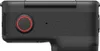 A close-up side view of a black action camera with a red-ringed button. Anteprima dell’immagine prodotto