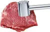 A meat tenderizer is shown being used on a piece of raw meat. Produktbild-Vorschau