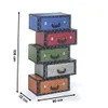 A stack of five decorative storage boxes resembling vintage suitcases, each a different color, arranged vertically. Produktbild-Vorschau