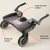 A black Lascal Buggy Board Maxi with orange arrows pointing to its features. Náhled obrázku produktu