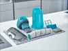 A set of vacuum cleaner accessories laid out on a grey and white patterned cloth on a white countertop. Produktbild-Vorschau