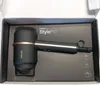 A black hairdryer with rose gold accents is displayed inside its packaging box. Podgląd zdjęcia produktu