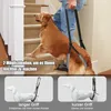 A golden retriever dog is being helped up stairs by a person using a dog lifting harness. Two smaller images at the bottom show the harness with different grip lengths. Produktbild-Vorschau