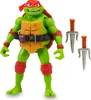 A toy action figure of Raphael from Teenage Mutant Ninja Turtles, standing with his weapons. Produktbild-Vorschau