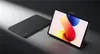A tablet and its cover are displayed on a dark, reflective surface. Produktbild-Vorschau