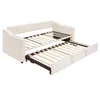 A beige upholstered daybed with its trundle pulled out, showing the slatted mattress bases. Náhľad obrázku produktu