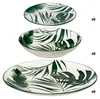 Three plates with a palm leaf pattern are stacked on a white background. Náhľad obrázku produktu