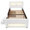A white bed frame with a slatted base, illuminated by LED lights in the headboard and base. Produktbild-Vorschau