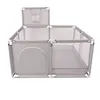 A grey fabric playpen with white metal frame and a small basket attached to the top. Anteprima dell’immagine prodotto