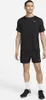 A man wearing a black Nike t-shirt and shorts, standing against a white background. Podgląd zdjęcia produktu