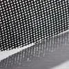 A close-up of a black mesh material with a grid pattern, casting a shadow on a brushed metal surface. Produktbild-Vorschau
