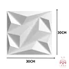 A white 3D wall panel with geometric facets, shown with dimensions indicated by text and lines. Produktbild-Vorschau