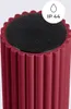 Close-up of the top of a burgundy colored, fluted light fixture with a black insert and a white circle containing the text 'IP 44' and a water droplet icon. Produktbild-Vorschau