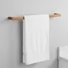 A white towel hanging on a copper towel rack mounted on a light gray wall. Produktbild-Vorschau