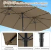 Close-up view of a double patio umbrella, showing its structure and details, with a blue sky background. Podgląd zdjęcia produktu
