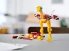 A LEGO creation of a creature stands on a table with scattered LEGO bricks around it. Náhled obrázku produktu