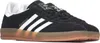 A pair of black Adidas Gazelle sneakers with white stripes and a gum sole. Produktbild-Vorschau