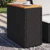 An outdoor table with a book and a cup on it, placed on a rug. Produktbild-Vorschau