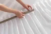 Hands adjusting a white curtain with a curtain rod. Produktbild-Vorschau