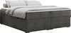 A dark gray boxspring bed with a low headboard, dressed with white and light gray bedding and a small beige bolster pillow. Produktbild-Vorschau