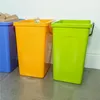 Three recycling bins are lined up against a wall. Náhled obrázku produktu