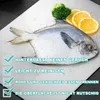 A raw fish, broccoli, and lemon slices are arranged on a silver cutting board, with water droplets scattered across the surface. Text overlays highlight product features. Produktbild-Vorschau