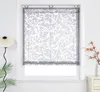 A window with a decorative Roman shade, a floor lamp, and a vase with branches on a nightstand. Produktbild-Vorschau