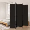 A black room divider is shown in a bedroom setting next to a bed. Produktbild-Vorschau