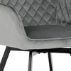 A close-up view of a modern dining chair with gray velvet upholstery and black metal legs. Náhled obrázku produktu