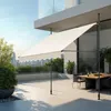 An outdoor patio with a retractable awning extended over a dining table. Náhled obrázku produktu