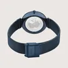 The back of a blue Bering watch with a mesh band is shown against a light gray background. Produktbild-Vorschau