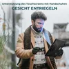 A man in winter clothing is using a tablet outdoors, with a facial recognition overlay on his face. Produktbild-Vorschau