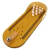 A wooden tabletop bowling game with pins and a ball. Produktbild-Vorschau