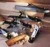 A collection of woodworking planes arranged on wooden planks, with wood shavings scattered around. Voir les images du produit