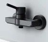 A black shower faucet mounted on a light gray wall. Produktbild-Vorschau