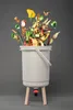 A composting bin with food scraps overflowing from the top. Náhled obrázku produktu