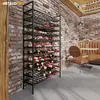 A wine rack filled with wine bottles in a room with brick walls and a leather booth. Náhľad obrázku produktu