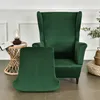 A green velvet wingback chair and matching ottoman are shown in a room setting. Anteprima dell’immagine prodotto
