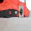 Close-up view of a red electric planer resting on a light-colored surface. Produktbild-Vorschau