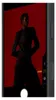 A person is posing in front of a red background on a phone screen. Podgląd zdjęcia produktu