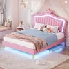 A child's bedroom with a pink bed and decorative elements.