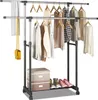 A clothing rack with clothes on hangers and shoes on the bottom shelf. Anteprima dell’immagine prodotto