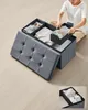 A person is organizing clothes in a storage ottoman. Náhled obrázku produktu