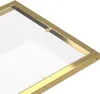 A close-up view of the corner of a glass table with a gold frame. Produktbild-Vorschau