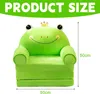 A green frog-shaped children's couch with a crown on its head, shown on a white background with size indicators. Produktbild-Vorschau