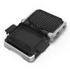 An open contact grill with a ribbed top plate and a flat bottom plate, set against a white background. Produktbild-Vorschau