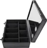 An open black makeup case with multiple compartments and a mirrored lid. Produktbild-Vorschau