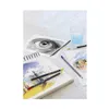 Art supplies including pencils, a sketchbook, and a glass of water are arranged on a wooden surface. Produktbild-Vorschau
