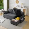 A gray sectional sofa with its storage ottoman open, revealing stored items like pillows and blankets. The sofa is in a living room setting with a window and a cabinet in the background. Podgląd zdjęcia produktu
