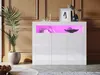 A white high-gloss sideboard with pink LED lighting, decorated with books and a bowl of decorative spheres. A potted plant is to the left, and framed art and a vase are on top. Podgląd zdjęcia produktu